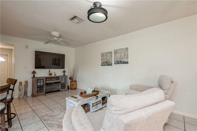 tiled living room featuring ceiling fan