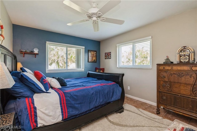 bedroom featuring multiple windows, tile patterned floors, and ceiling fan