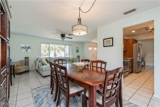 tiled dining area featuring ceiling fan