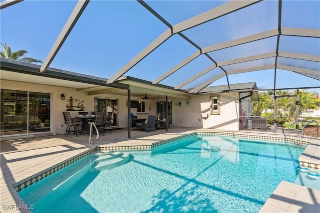 view of pool featuring a lanai, a patio, ceiling fan, and central air condition unit