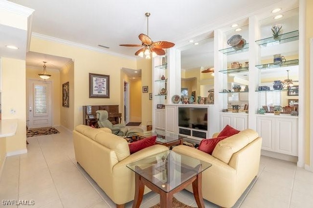 living room with ceiling fan, light tile patterned floors, and crown molding