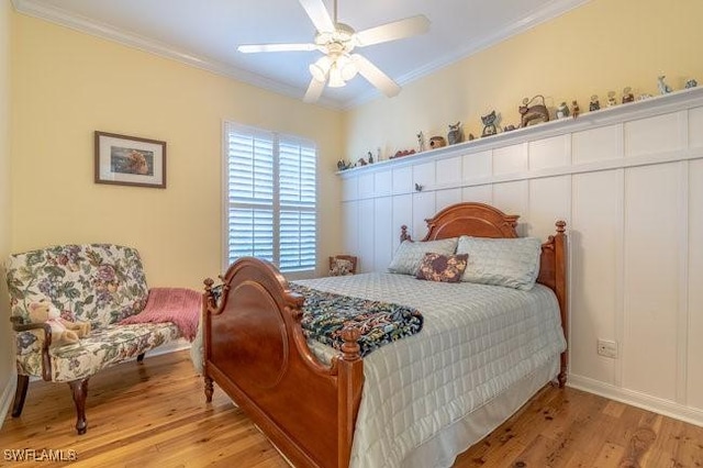 bedroom featuring ceiling fan, light wood-type flooring, and ornamental molding