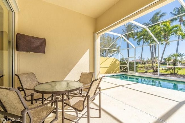 view of swimming pool with a lanai and a patio