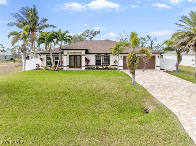 ranch-style house with french doors, a garage, and a front yard