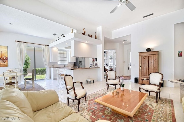 living room with ceiling fan and light tile patterned floors