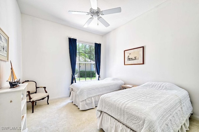 bedroom with ceiling fan and light colored carpet