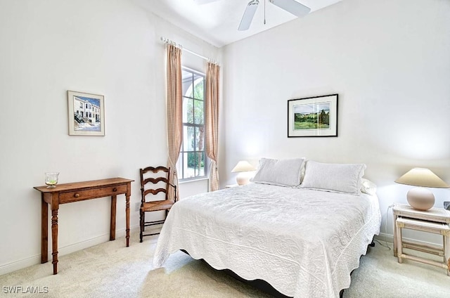 bedroom featuring ceiling fan, multiple windows, and light carpet