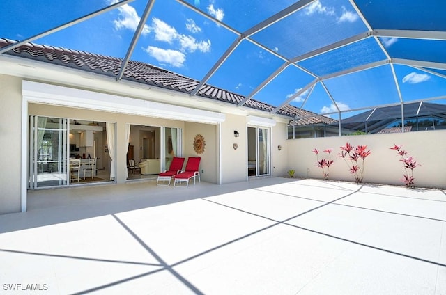 view of patio featuring glass enclosure