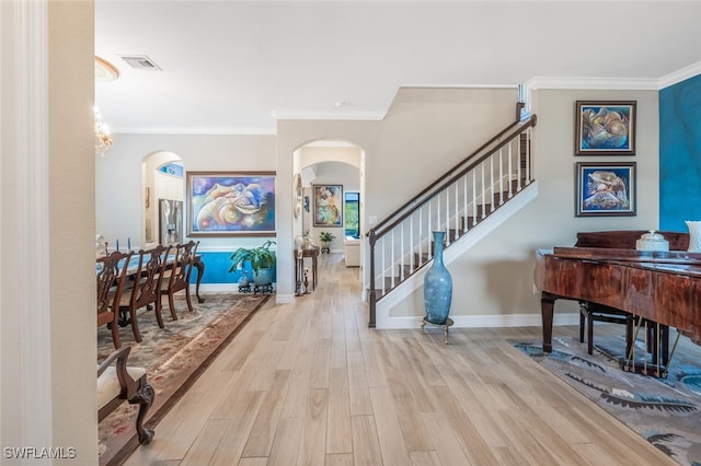 entryway featuring light hardwood / wood-style flooring and crown molding