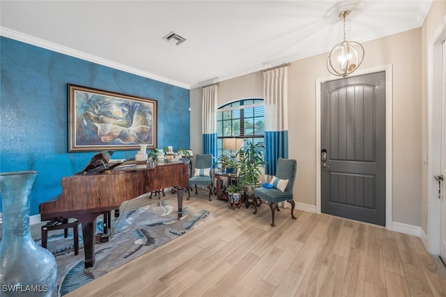 interior space with light hardwood / wood-style flooring, crown molding, and a chandelier