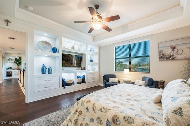 bedroom featuring visible vents, crown molding, a tray ceiling, and dark wood-style flooring