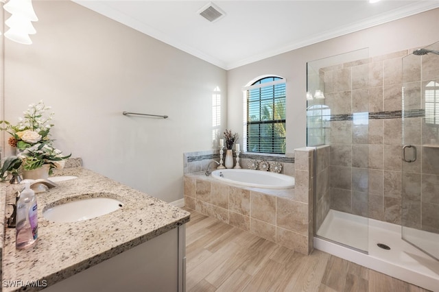 bathroom with crown molding, visible vents, a sink, a shower stall, and a bath