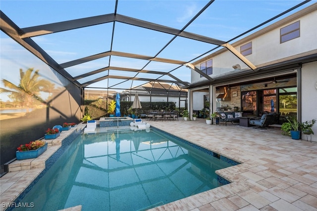 view of swimming pool with a lanai, an outdoor living space, a patio area, and a hot tub