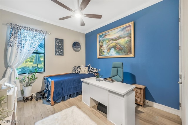 bedroom featuring ornamental molding, light wood-type flooring, a ceiling fan, and baseboards