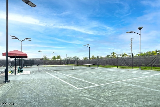 view of tennis court with fence