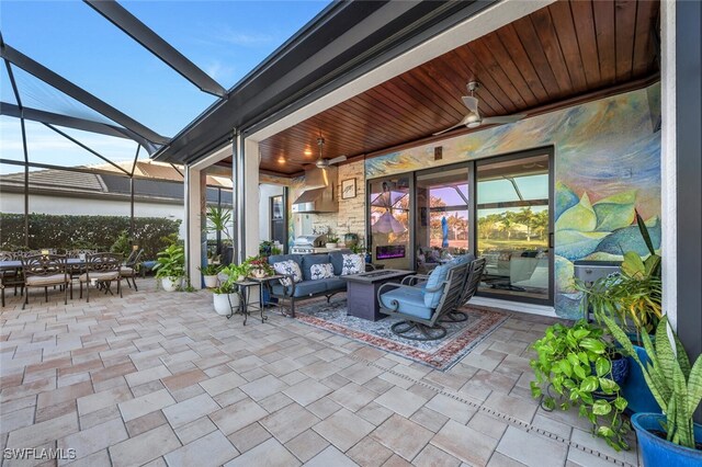 view of patio / terrace with a lanai, an outdoor hangout area, and ceiling fan