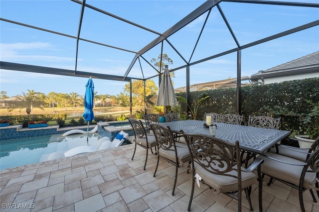 view of patio with a lanai and a pool with connected hot tub