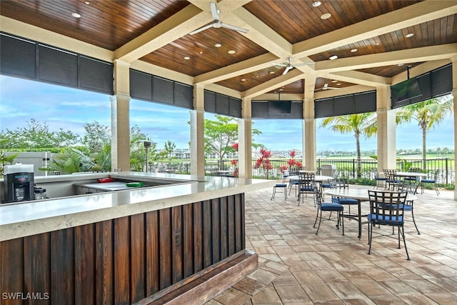 view of patio with fence and a ceiling fan