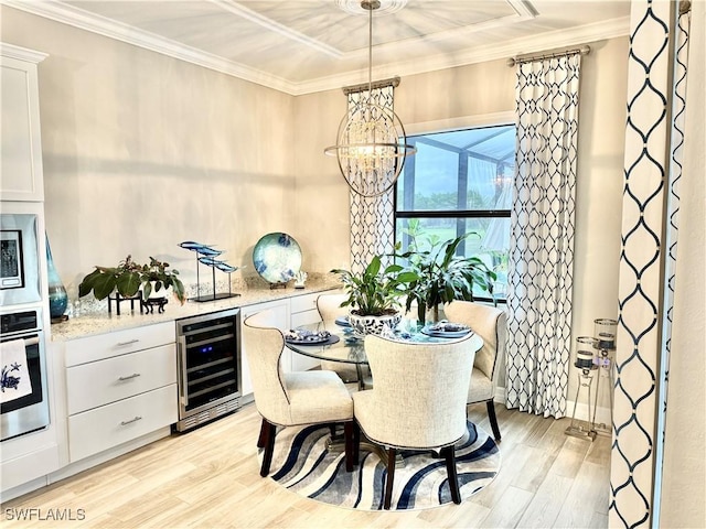 dining room featuring light wood-style floors, wine cooler, and crown molding