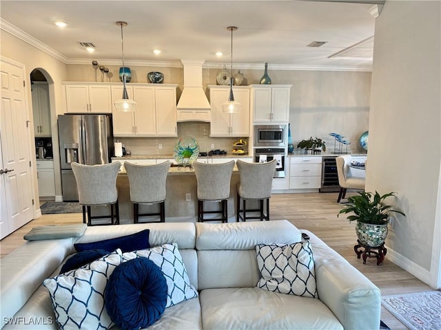 kitchen featuring appliances with stainless steel finishes, open floor plan, and hanging light fixtures