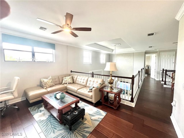 living room featuring dark wood-type flooring, visible vents, and baseboards