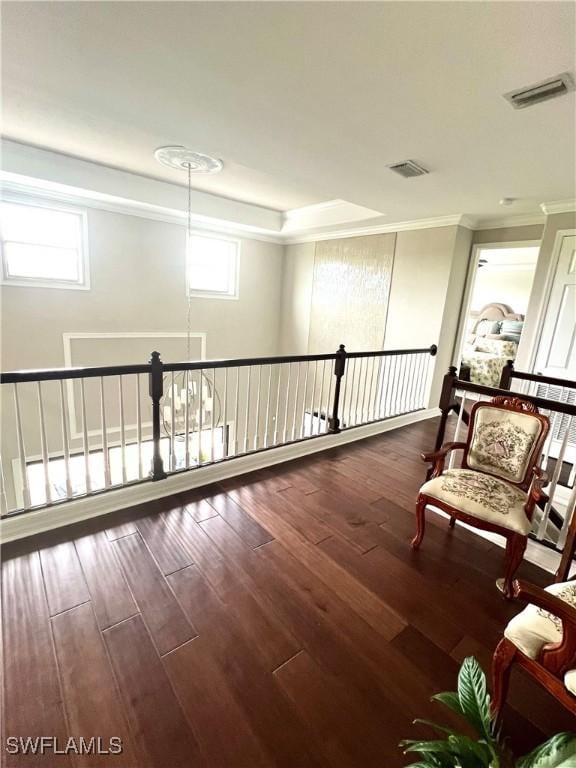 living area with dark wood-style floors, a wealth of natural light, and visible vents