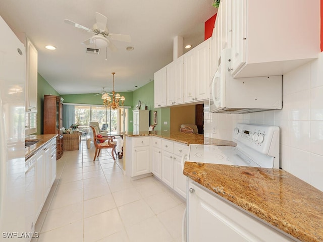 kitchen with white cabinetry, kitchen peninsula, lofted ceiling, light stone countertops, and pendant lighting