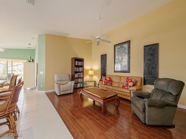 living room with ceiling fan and wood-type flooring