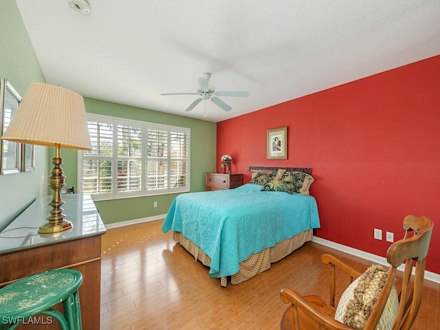 bedroom featuring ceiling fan and hardwood / wood-style flooring