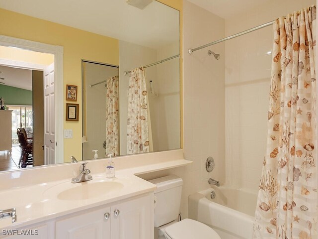 full bathroom with toilet, vanity, and shower / tub combo