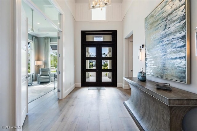 foyer entrance featuring light hardwood / wood-style floors and french doors