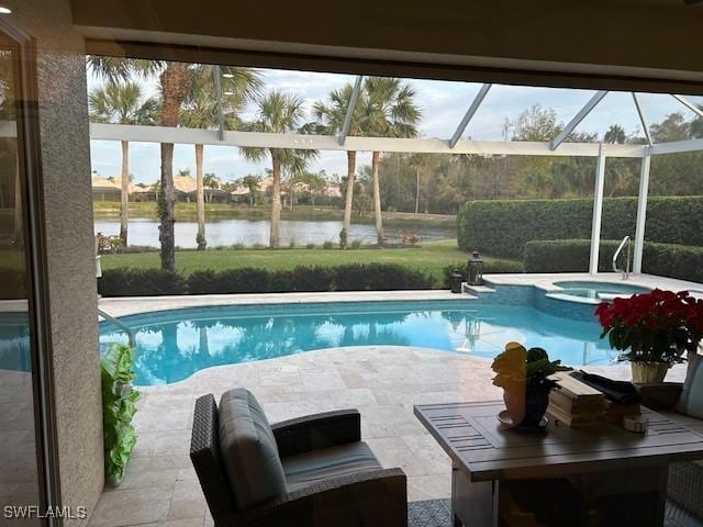 view of pool with glass enclosure, a water view, an in ground hot tub, and a patio