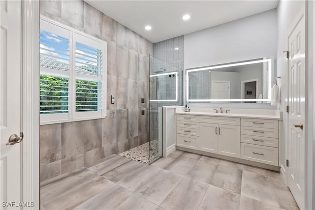 full bath featuring a stall shower, vanity, and recessed lighting