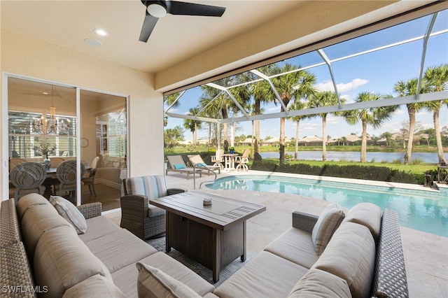 living room featuring a water view, a sunroom, ceiling fan, and recessed lighting