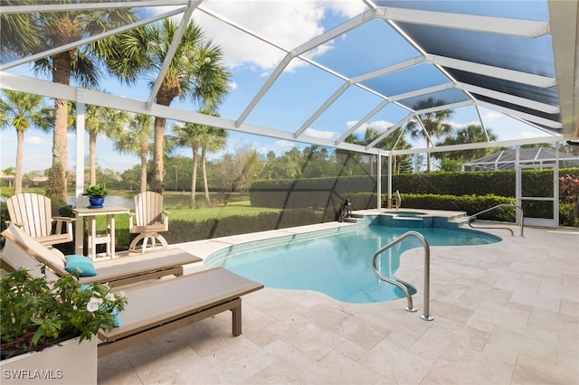 view of pool featuring a lanai, a patio area, and a pool with connected hot tub