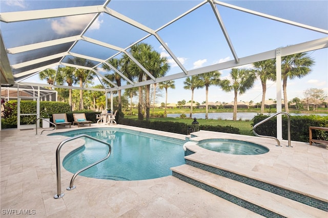 view of pool with a pool with connected hot tub, a lanai, a patio area, and a water view