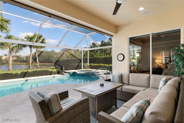 view of pool featuring ceiling fan, a patio area, an outdoor living space, and a water view