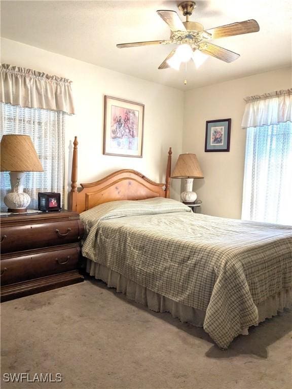 bedroom with ceiling fan and carpet flooring