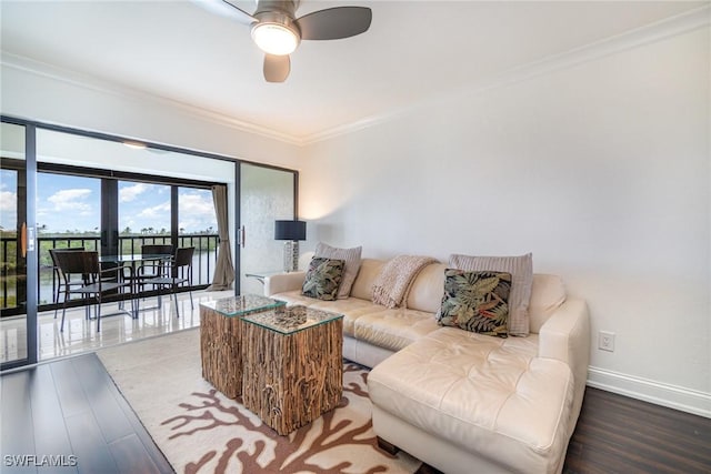 living room featuring ceiling fan, ornamental molding, and hardwood / wood-style floors