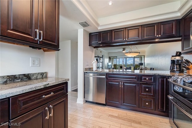 kitchen featuring light stone countertops, stove, dishwasher, and dark brown cabinetry