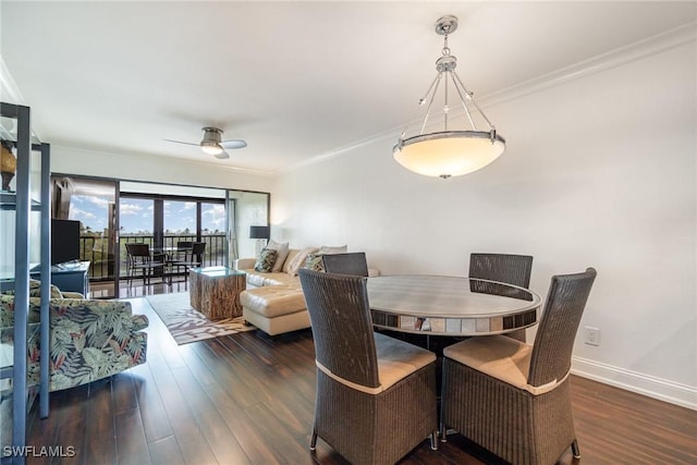 dining space featuring ceiling fan, dark wood-type flooring, and crown molding