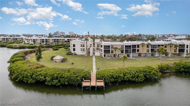 back of property featuring a yard and a water view