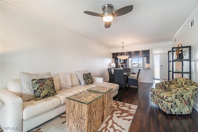 living room featuring ceiling fan, dark hardwood / wood-style flooring, and ornamental molding