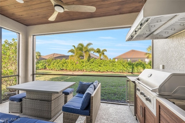 view of patio featuring ceiling fan, exterior kitchen, and area for grilling