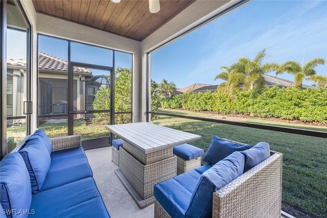 sunroom with ceiling fan and wood ceiling