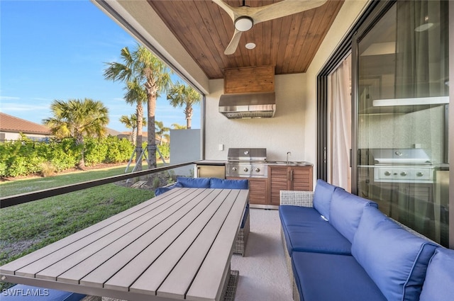 balcony featuring ceiling fan, a grill, an outdoor kitchen, and an outdoor hangout area