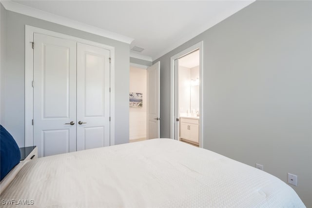 bedroom with ensuite bathroom and a closet