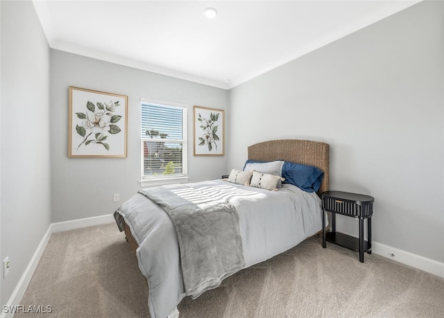 bedroom with carpet floors and crown molding