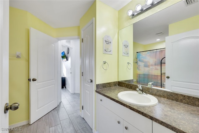 bathroom with vanity and curtained shower