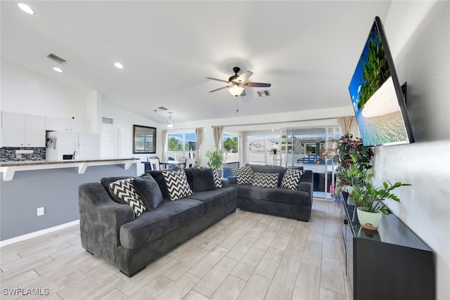 living room featuring ceiling fan and lofted ceiling